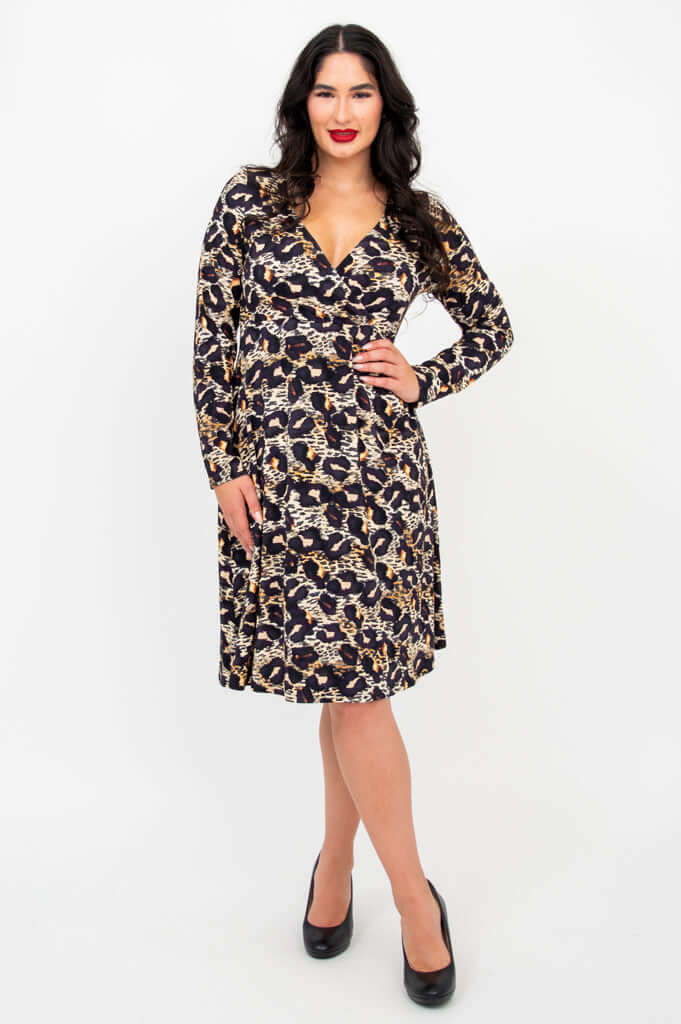 Woman modeling a long-sleeve leopard print empire waist dress with V-neckline