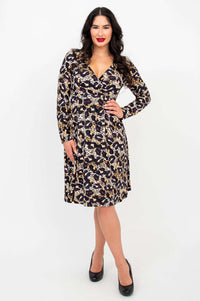 Woman modeling a long-sleeve leopard print empire waist dress with V-neckline