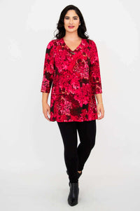 Woman walking forward in vibrant pink floral Vana tunic top