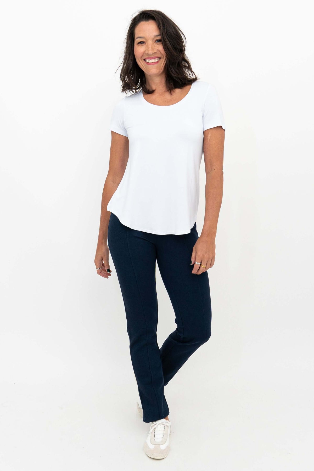 Woman wearing navy Nadia Pants with a white t-shirt, front view