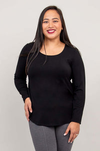 Woman wearing black long sleeve top with scoop neck, front view