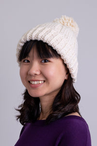 Women's cream beige knit toque wool hat with pompom.
