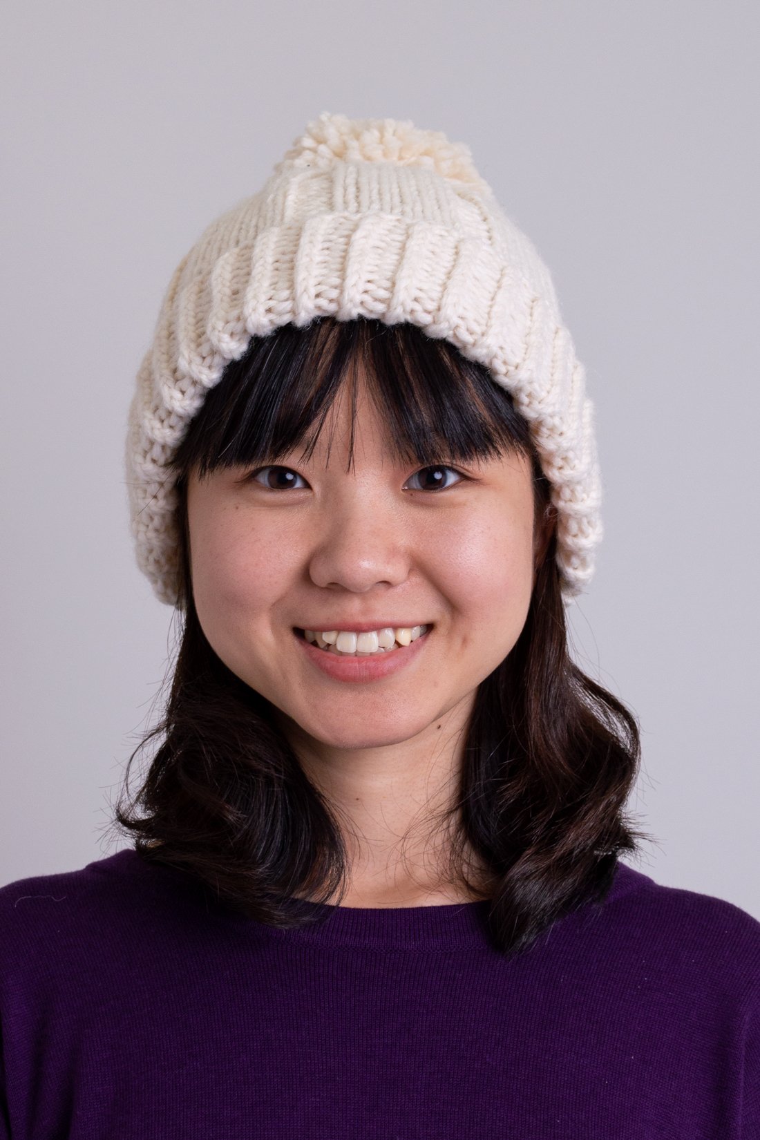 Women's cream beige knit toque wool hat with pompom.