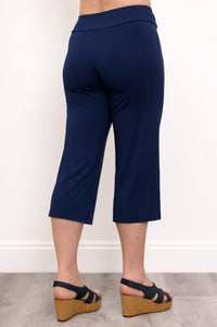 Back close up view of navy blue slime fit capri pants against a white background