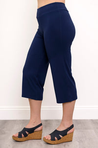 Side view of woman wearing indigo colored cropped pants and wedge sandals