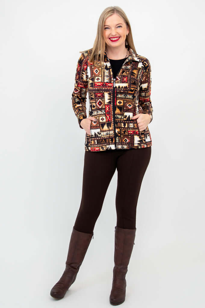 Woman facing camera in Sona bamboo zip jacket, brown leggings, and boots