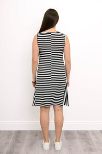 Back view of a woman wearing a sleeveless black and white striped bamboo dress with a round neckline and knee-length hem.